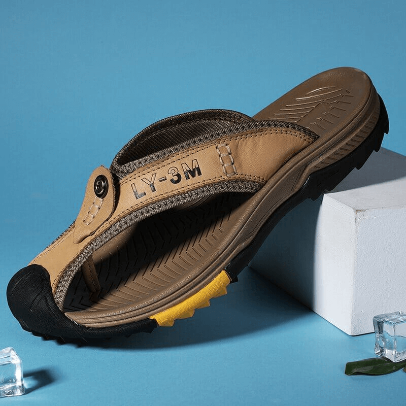 Stylish men's leather flip-flops with anti-slip rubber sole and padded insole on display.